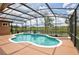 Screened in pool with a unique design and lush greenery, offering a private retreat at 1528 Langham Ter, Lake Mary, FL 32746