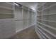 Spacious walk-in closet with custom shelving and ample storage for all your wardrobe needs at 1528 Langham Ter, Lake Mary, FL 32746