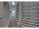 Well-lit walk-in closet with shelving and a window, providing a bright space for organization at 1528 Langham Ter, Lake Mary, FL 32746