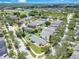 An aerial view captures a home nestled in a residential area with nearby ponds and a school at 1531 Tiverton Blvd, Winter Garden, FL 34787