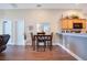 Cozy dining area with wood floors, table seating for four, and adjacent kitchen bar seating at 1531 Tiverton Blvd, Winter Garden, FL 34787