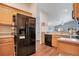 Kitchen features black refrigerator and appliances, wood cabinetry and countertops at 1531 Tiverton Blvd, Winter Garden, FL 34787
