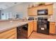 Kitchen featuring stainless steel appliances, wood cabinetry, and spacious countertops at 1531 Tiverton Blvd, Winter Garden, FL 34787