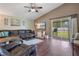 Inviting living room with hardwood floors, a TV, and sliding door access to the screened porch at 1531 Tiverton Blvd, Winter Garden, FL 34787
