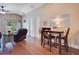 Cozy living room with vaulted ceilings, wood floors, dining area, and sliding glass doors at 1531 Tiverton Blvd, Winter Garden, FL 34787