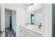 Bathroom with double vanity, quartz countertop and a shower over tub, and wood look flooring at 15625 Sw 37Th Cir, Ocala, FL 34473