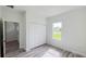 Bedroom featuring wood-look flooring, closet and a window overlooking the yard at 15625 Sw 37Th Cir, Ocala, FL 34473