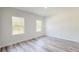 An airy bedroom with two large windows offering plenty of natural light and views of the surrounding greenery at 15625 Sw 37Th Cir, Ocala, FL 34473