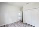 Bedroom featuring wood-look flooring, closet and a view into another room through an open door at 15625 Sw 37Th Cir, Ocala, FL 34473