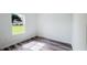 A bright bedroom with wood-look flooring, a window overlooking the front yard and white trim at 15625 Sw 37Th Cir, Ocala, FL 34473
