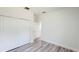 Bedroom featuring wood-look flooring, a closet and a view into another room through an open door at 15625 Sw 37Th Cir, Ocala, FL 34473