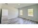 A bright bedroom with two windows, neutral walls and modern flooring offers a serene and comfortable living space at 15625 Sw 37Th Cir, Ocala, FL 34473