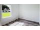 A bright bedroom with wood-look flooring, a window overlooking the front yard and white trim at 15625 Sw 37Th Cir, Ocala, FL 34473