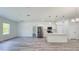 Well-lit kitchen featuring stainless steel appliances, white cabinets, and a center island with seating at 15625 Sw 37Th Cir, Ocala, FL 34473