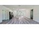 Open-concept living area featuring wood-look floors, stainless steel appliances, and a kitchen island at 15625 Sw 37Th Cir, Ocala, FL 34473