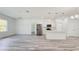 Bright, open-concept living area with modern flooring and a stylish kitchen featuring stainless steel appliances and a breakfast bar at 15625 Sw 37Th Cir, Ocala, FL 34473