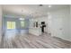 Spacious living area with wood-look floors, stainless steel appliances, and sliding glass doors to the backyard at 15625 Sw 37Th Cir, Ocala, FL 34473