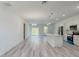 Bright and spacious living room boasts an open floor plan and modern gray wood-look floors at 15625 Sw 37Th Cir, Ocala, FL 34473