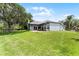 Expansive backyard features lush lawn, mature trees and a covered patio, perfect for entertaining at 1640 Wild Indigo Ter, Oviedo, FL 32766