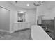 A modern bathroom featuring a large white vanity and soaking tub at 1640 Wild Indigo Ter, Oviedo, FL 32766
