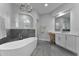 Bright bathroom featuring a modern soaking tub, shower, and stylish vanity at 1640 Wild Indigo Ter, Oviedo, FL 32766