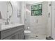 Bathroom with modern vanity and glass-enclosed shower with a window at 1640 Wild Indigo Ter, Oviedo, FL 32766