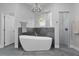 Bright bathroom featuring a modern soaking tub, shower, and stylish fixtures at 1640 Wild Indigo Ter, Oviedo, FL 32766