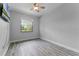 Empty bedroom with a ceiling fan, window, and light-gray floors at 1640 Wild Indigo Ter, Oviedo, FL 32766