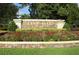 Stone sign for Live Oak Preserve surrounded by colorful flowers and greenery, creating a welcoming entrance at 1640 Wild Indigo Ter, Oviedo, FL 32766