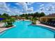 Large community pool with palm trees, lounge chairs, and cabanas, ideal for relaxation and socializing at 1640 Wild Indigo Ter, Oviedo, FL 32766