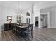 Formal dining room featuring wood floors, neutral walls, and modern chandelier at 1640 Wild Indigo Ter, Oviedo, FL 32766