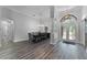 Elegant entryway with wood flooring, archways, and a formal dining area at 1640 Wild Indigo Ter, Oviedo, FL 32766