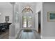 Elegant entryway with wood flooring, archways, and a modern light fixture at 1640 Wild Indigo Ter, Oviedo, FL 32766