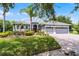 Charming single-story home with a manicured lawn, mature landscaping, and a three-car garage at 1640 Wild Indigo Ter, Oviedo, FL 32766