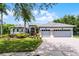 Charming single-story home with a manicured lawn, mature landscaping, and a three-car garage at 1640 Wild Indigo Ter, Oviedo, FL 32766
