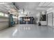 Spacious garage with an overhead storage rack and well-organized storage cabinets at 1640 Wild Indigo Ter, Oviedo, FL 32766