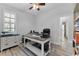 Comfortable home office with modern desk, gray color palette, and natural light at 1640 Wild Indigo Ter, Oviedo, FL 32766
