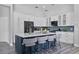 Updated kitchen boasts island seating, modern appliances, and ample cabinet space for storage at 1640 Wild Indigo Ter, Oviedo, FL 32766