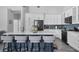 Bright kitchen with island seating, stainless appliances, and classic white cabinetry at 1640 Wild Indigo Ter, Oviedo, FL 32766