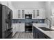 Modern kitchen features stainless steel appliances, blue backsplash, and white shaker cabinets at 1640 Wild Indigo Ter, Oviedo, FL 32766