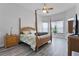 Serene main bedroom features stylish four-poster bed, modern windows, and gray color palette at 1640 Wild Indigo Ter, Oviedo, FL 32766