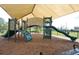 Community playground on soft mulch ground with slides and climbing areas, perfect for entertainment at 1640 Wild Indigo Ter, Oviedo, FL 32766