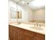 Bathroom features a double sink vanity with neutral countertop, dark wood cabinets, and large mirror at 1649 Lake Baldwin Ln, Orlando, FL 32814