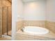 Bathroom with large tub and glass-enclosed shower at 1649 Lake Baldwin Ln, Orlando, FL 32814