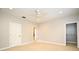 Spacious bedroom featuring neutral walls, plush carpeting, ceiling fan, and an adjoining walk-in closet at 1649 Lake Baldwin Ln, Orlando, FL 32814
