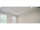 Bright bedroom with neutral walls, ceiling fan, and plantation shutters on the windows at 1649 Lake Baldwin Ln, Orlando, FL 32814