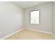 Bedroom with beige carpet, base molding, and a window at 1649 Lake Baldwin Ln, Orlando, FL 32814
