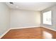 Sunlit bedroom with hardwood floors, a large window, and neutral wall paint at 1649 Lake Baldwin Ln, Orlando, FL 32814