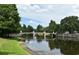 Charming bridge over a tranquil waterway surrounded by lush greenery and mature trees at 1649 Lake Baldwin Ln, Orlando, FL 32814