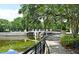 Picturesque bridge over calm water, framed by trees and a walking path, enhancing the community's charm at 1649 Lake Baldwin Ln, Orlando, FL 32814